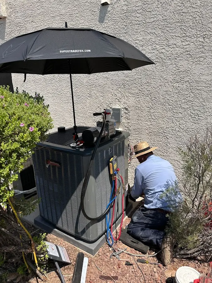 HVAC technician performing outdoor AC maintenance in Osceola