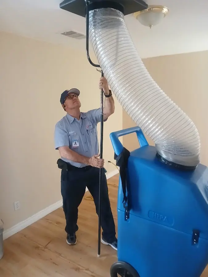 Furnace Tune-Up technician using HEPA equipment in Osceola